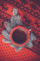 handmade red sweate hot cup of tea, Christmas tree and New Year's decor