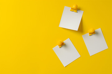 White colored blank empty unfilled 3 paper sheets or sticky notes isolated on copy space yellow background, front view of adhesive paper notes, 3 paper office stickers with shadows, empty 3 text boxes