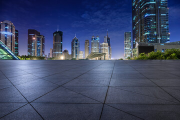 City square floor and modern commercial building scenery at night in Shanghai. Famous financial...
