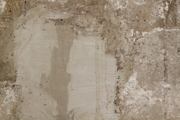 A worn and plastered interior concrete wall.