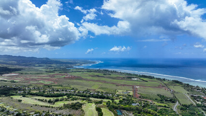 Aerial View of Lush Green Field Next to Ocean - Powered by Adobe