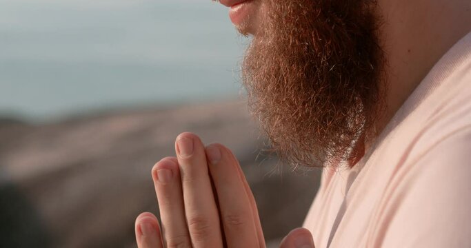 Man with beard yoga pose eyes closed palms close-up namaste. Namaste embodying peace nature's meditation Namaste symbol of mental health and tranquility Harmony with self and surroundings.