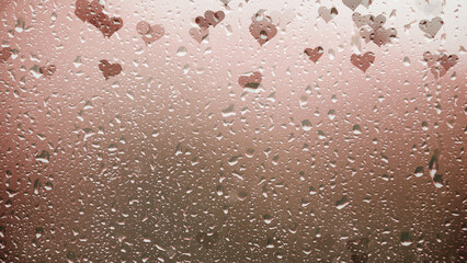  Sad heart symbols on copy space wet rainy window background.