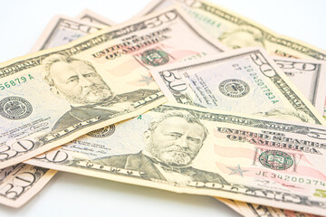 US paper money. Bribery with a wad of money, cash circulation and money exchange currency. Fifty 50 dollar bills fanned out on a white background. Lots of 50 dollar bills, the concept of American cash