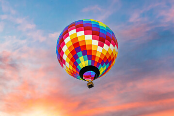 Colorful hot air balloon flying at sunset	