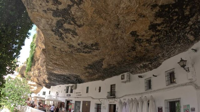 Buildings under a rock in in Setenil de Las Bodegas town in Andalusia, Spain