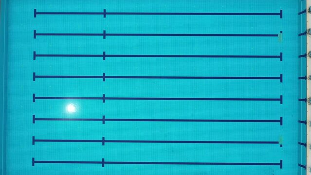 A Large Swimming Pool With a Blue Tiled Floor