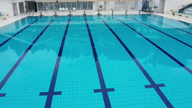 A Large Swimming Pool With a Blue Tiled Floor