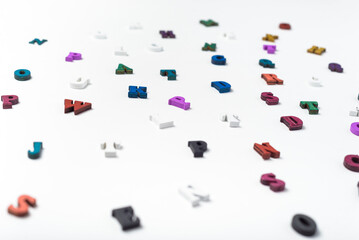 Scattered colored letters on a white background. Reading or education concept.
