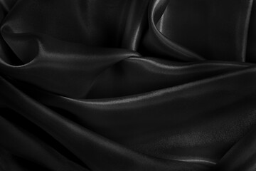 Black fabric cloth texture for background and design art work, beautiful crumpled pattern of silk or linen.