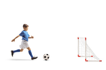 Boy running with a football to score a goal