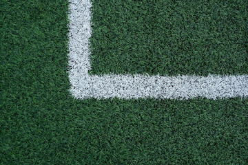 Synthetic grass of soccer pitch with white lines, texture, close-up. Design element for...