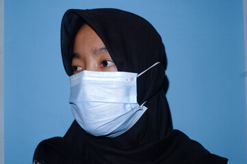 Wonosobo, Indonesia 1-3-2021 a woman wearing a black headscarf-wearing a mask with various styles,...