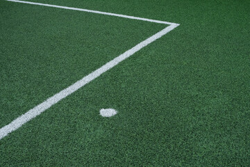 Obraz premium Artificial green grass, football field surface. Top-down view of green synthetic grass with white markings. Design element, copy space