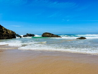 Rocky ocean coast, ocean bay with rocky coast and sand beach, blue sky, no people