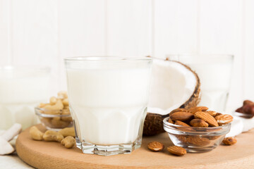Set or collection of various vegan milk almond, coconut, cashew, on table background. Vegan plant based milk and ingredients, top view