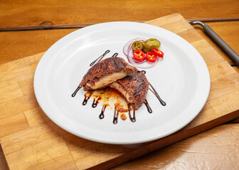 Beefsteak with mozzarella cheese in a plate on a wooden board