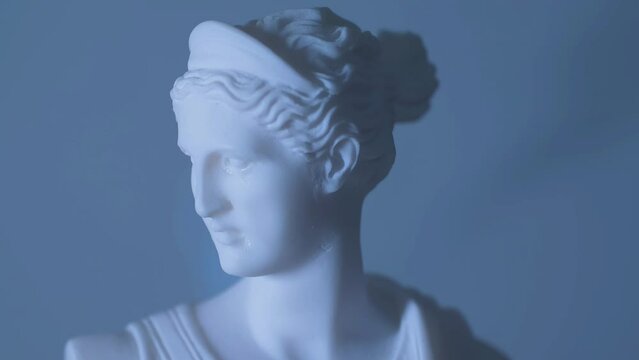 Rotating statue of the Greek God Artemis in warm light