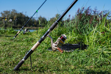 Fishing rods on the background of the lake at dawn. Fishing, recreation, hobby. Copy space.