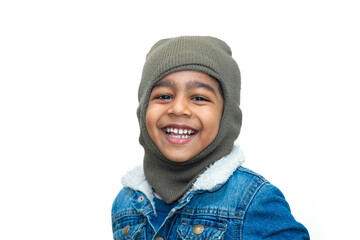 Asian boy wearing jeans jackets and monkey caps. A fashionable boy in heavy winter clothes looking at the camera.
