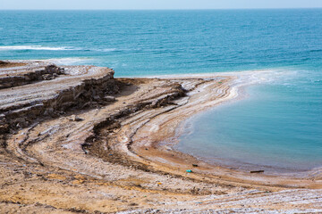 View of Dead Sea coastline at sunset time in Jordan. Salt crystals at sunset. Dead sea landscape...