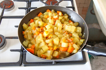 Zucchini with and onion carrots stew in a pan