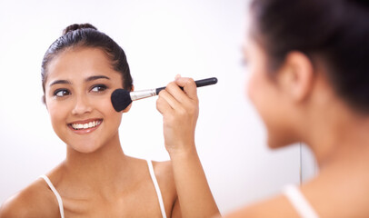 Happy woman, makeup brush and face in mirror for cosmetics, grooming or beauty in bathroom at home. Female person smile and applying foundation, blush or contour for facial treatment in reflection