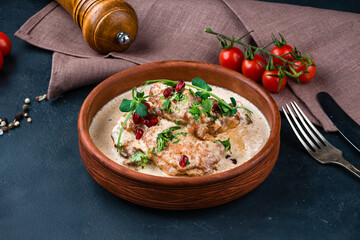 Georgian lunch soup chikhirtma with meat, pomegranate seeds and herbs.