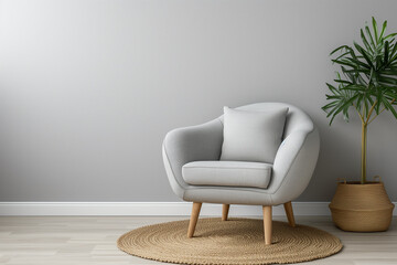 Chic armchair setup with a pillow and rug against a soft grey wall, space for text