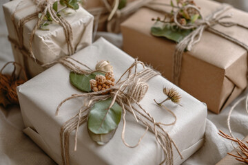 Resourceful and sustainable gift wrapping using natural elements such as twine, leaves, and dried flowers, celebrating eco-friendly practices. Soft fo