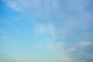 A beautiful sky tinted by the sun leaving vibrant shades of gold, pink, blue and multicolored. Clouds in the twilight evening and morning sky. Cloudy sky background in the evening and during the day.