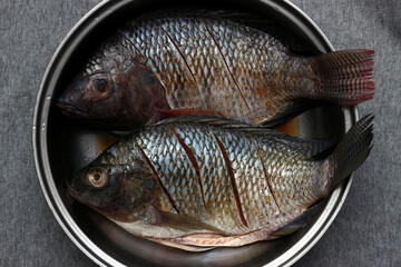 Prepare the tilapia for frying.