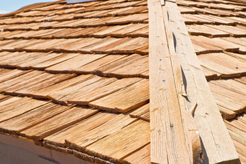 Old traditional roof with wooden shingles - wooden tiles roof construction of traditional rural and...