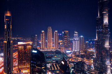 Modern downtown United Arab Emirates, sky with stars. Dubai night amazing skyline cityscape with...