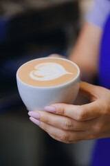 Barista make hot milk for latte art coffee on machine in craft cafe small business
