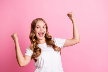 Portrait of young awesome gorgeous model raised fists up winning scream and promoting noname brand...