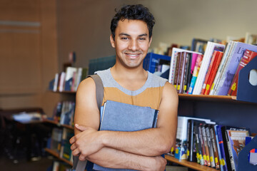 Portrait, arms crossed or happy man in library for education or development for future growth....