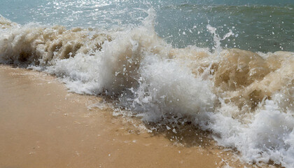Fototapeta premium hard wave water hit sand in close up at beach