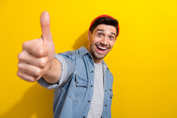 Photo of impressed funky guy wear denim jacket showing you thumb up isolated yellow color background - obrazy, fototapety, plakaty