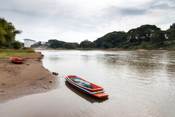 Fototapeta premium Boat with fishing equipment for catch fish floating in the river or local fishery concept. 