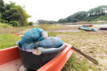 Nylon silk nets fishing equipment in enameled bowl for catch fish in the river or local fishery concept. 