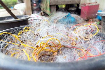 Nylon silk nets fishing equipment for catch fish. Old net after fishery commerce micro plastic in water pollution concept. Environment problem in the river or ocean.