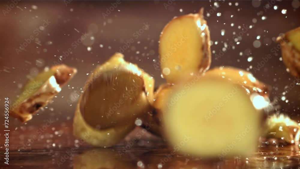 Sticker pieces of fresh ginger fall on the table. filmed on a high-speed camera at 1000 fps. high quality fu