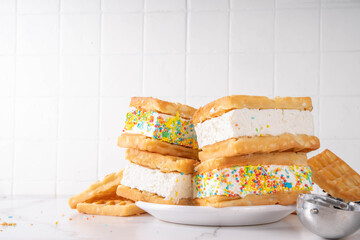 Waffle ice cream sandwiches. Tasty ice cream with fluffy belgian waffles and sugar sprinkles,...