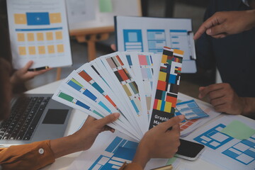 Close up ux developer and ui designer use augmented reality brainstorming about mobile app interface wireframe design on desk at modern office.Creative digital development agency