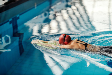 Professional sports girl in action. A swimmer swimming in long axis stroke style.