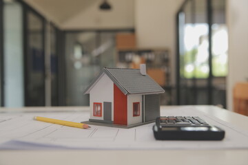 Male and Female Industrial Engineers in Hard Hats Discuss New Project while Using Laptop. They Make Showing Gestures.They Work in a Heavy Industry Manufacturing Factory.