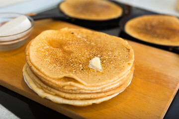 Stack of appetizing flour pancake in the kitchen during cooking