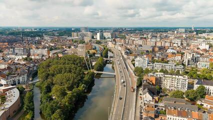 Fototapeta na wymiar Ghent, Belgium. Esco (Scheldt) river embankment. Panorama of the city from the air. Cloudy weather, summer day, Aerial View