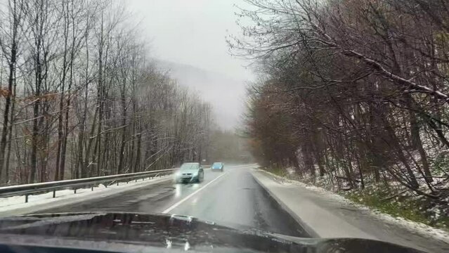 Ukraine, Carpathians, winter snowy Transcarpathia, car speed on mountain turns as a symbol of danger and sporty driving